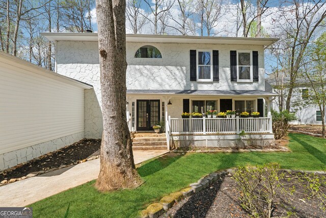 8012 Beachwood Dr, Murrayville, GA 30564 - view of front of house featuring french doors, covered porch, and a front yard