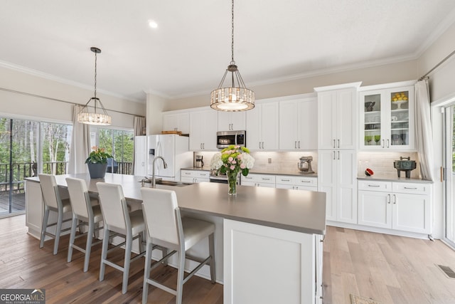 8012 Beachwood Dr, Murrayville, GA 30564 - kitchen with white fridge with ice dispenser, a large island with sink, white cabinets, a chandelier, and stainless steel microwave