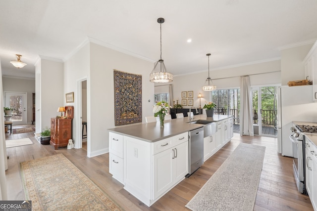 8012 Beachwood Dr, Murrayville, GA 30564 - kitchen featuring light wood-type flooring, white cabinets, a center island with sink, appliances with stainless steel finishes, and a sink