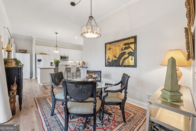 8012 Beachwood Dr, Murrayville, GA 30564 - dining room featuring a chandelier, light wood-type flooring, baseboards, and ornamental molding