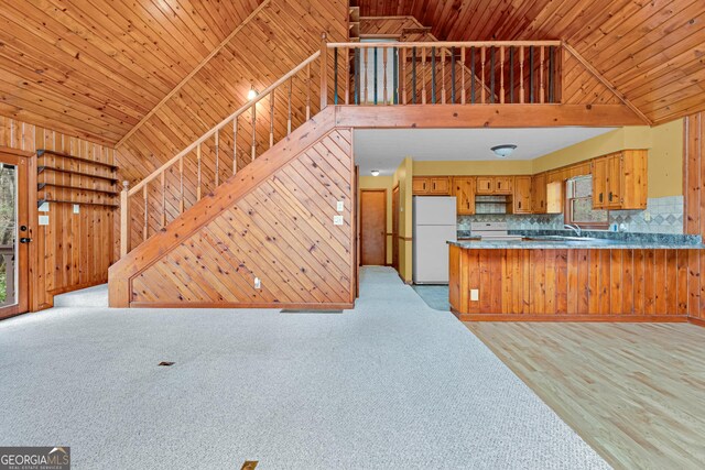 374 W Sugarbush Dr, Sky Valley, GA 30537 - kitchen with brown cabinets, wood walls, wooden ceiling, and white appliances