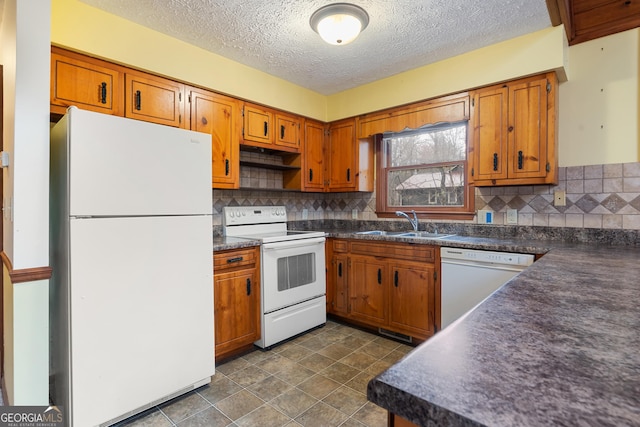 374 W Sugarbush Dr, Sky Valley, GA 30537 - kitchen featuring tasteful backsplash, a sink, dark countertops, white appliances, and brown cabinets