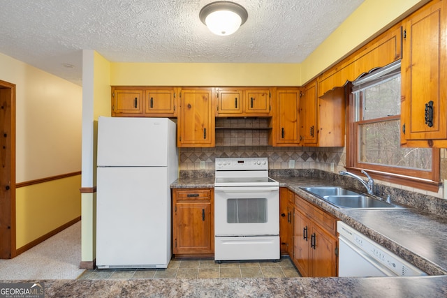 374 W Sugarbush Dr, Sky Valley, GA 30537 - kitchen featuring a sink, dark countertops, white appliances, brown cabinetry, and decorative backsplash
