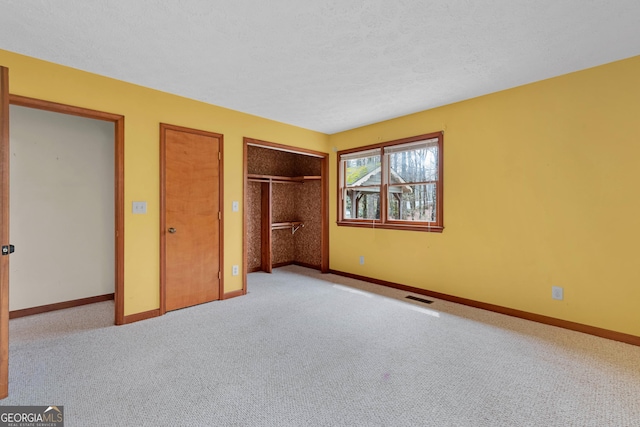 374 W Sugarbush Dr, Sky Valley, GA 30537 - unfurnished bedroom with visible vents, baseboards, a textured ceiling, multiple closets, and carpet flooring