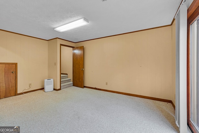 374 W Sugarbush Dr, Sky Valley, GA 30537 - carpeted empty room with crown molding, baseboards, a textured ceiling, and stairs