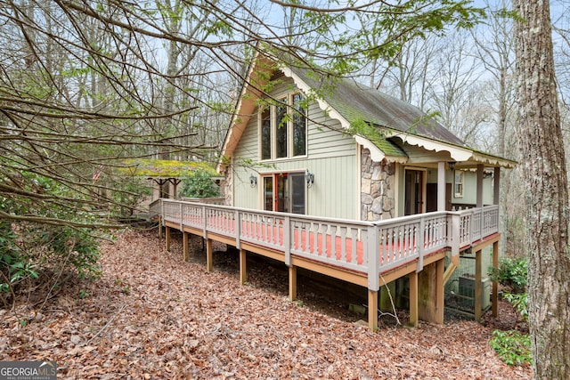374 W Sugarbush Dr, Sky Valley, GA 30537 - back of property featuring central AC, a wooden deck, and stone siding