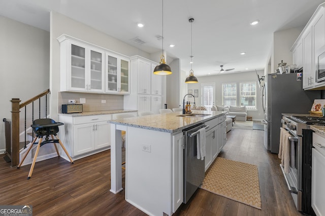 6023 Skellig St, Norcross, GA 30071 - kitchen featuring appliances with stainless steel finishes, open floor plan, dark wood finished floors, white cabinetry, and recessed lighting