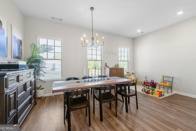 6023 Skellig St, Norcross, GA 30071 - dining area with wood finished floors, a chandelier, healthy amount of natural light, and recessed lighting