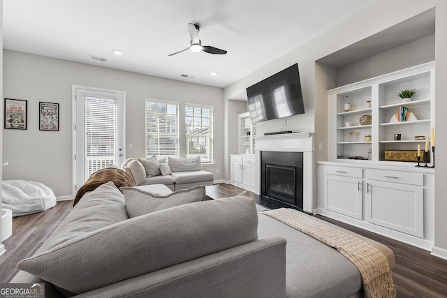 6023 Skellig St, Norcross, GA 30071 - living area with a ceiling fan, a fireplace with flush hearth, dark wood-style flooring, built in shelves, and recessed lighting