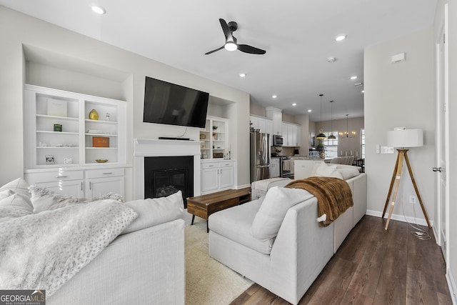 6023 Skellig St, Norcross, GA 30071 - living room with a ceiling fan, dark wood-type flooring, a glass covered fireplace, and recessed lighting