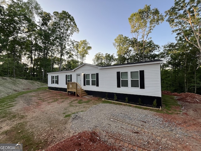 manufactured / mobile home featuring driveway and a deck