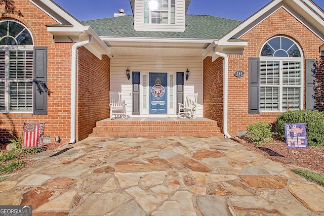 494 Thrash Rd, Lagrange, GA 30241 - property entrance with roof with shingles, brick siding, and a porch