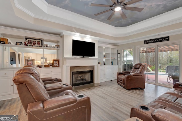 494 Thrash Rd, Lagrange, GA 30241 - living room with a tray ceiling, a ceiling fan, ornamental molding, a high end fireplace, and light wood-style floors