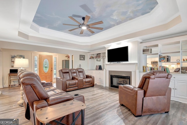 494 Thrash Rd, Lagrange, GA 30241 - living area featuring a tray ceiling, ceiling fan, ornamental molding, light wood-style floors, and a fireplace
