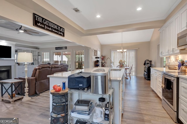494 Thrash Rd, Lagrange, GA 30241 - kitchen with electric stove, white cabinets, light wood-style flooring, light stone countertops, and recessed lighting