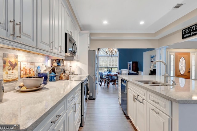 494 Thrash Rd, Lagrange, GA 30241 - kitchen with appliances with stainless steel finishes, a sink, wood finished floors, white cabinets, and a center island with sink