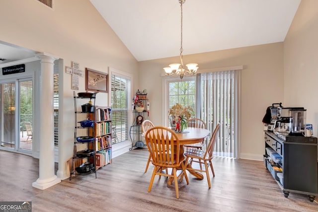 494 Thrash Rd, Lagrange, GA 30241 - dining space featuring decorative columns, light wood-style floors, a chandelier, baseboards, and high vaulted ceiling