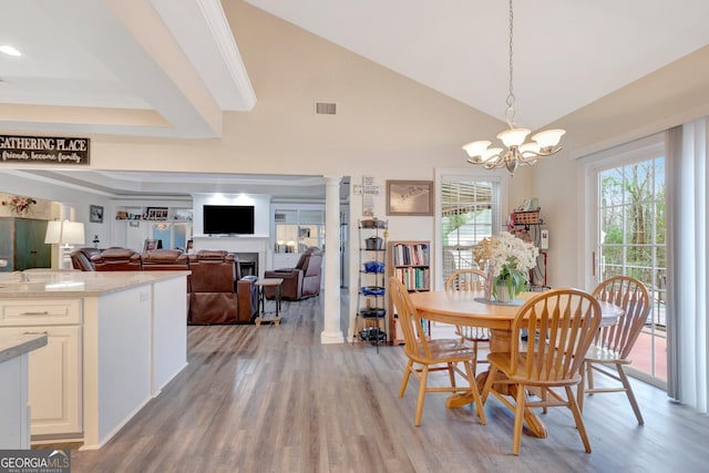 494 Thrash Rd, Lagrange, GA 30241 - dining space featuring light wood finished floors, a chandelier, vaulted ceiling, and a fireplace