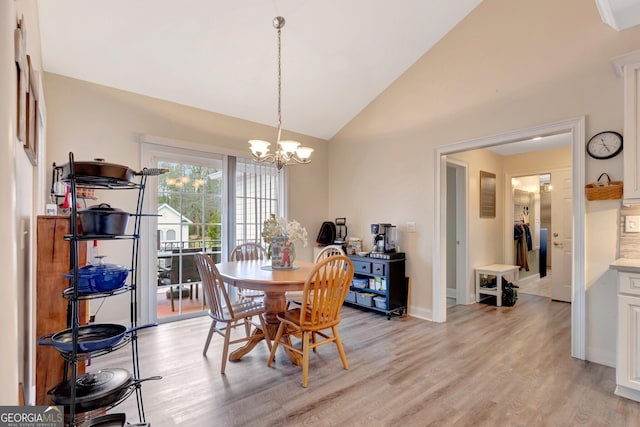 494 Thrash Rd, Lagrange, GA 30241 - dining space with light wood finished floors, a chandelier, baseboards, and high vaulted ceiling