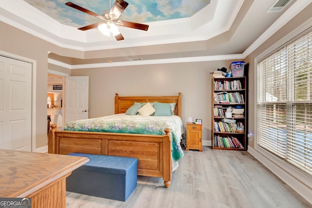 494 Thrash Rd, Lagrange, GA 30241 - bedroom with a tray ceiling, light wood-style flooring, ornamental molding, ceiling fan, and baseboards