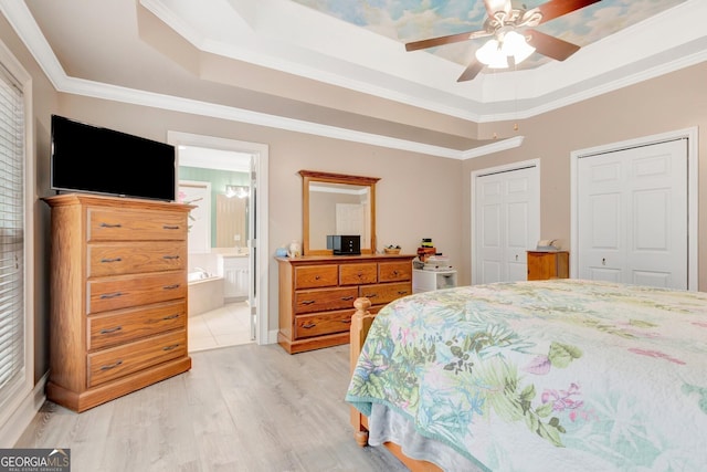 494 Thrash Rd, Lagrange, GA 30241 - bedroom with light wood-style floors, multiple closets, a tray ceiling, ornamental molding, and ensuite bath