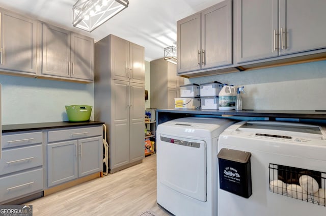 494 Thrash Rd, Lagrange, GA 30241 - laundry area with cabinet space, washer and clothes dryer, and light wood-style floors