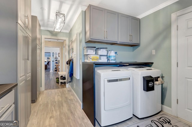 494 Thrash Rd, Lagrange, GA 30241 - laundry room with cabinet space, separate washer and dryer, crown molding, baseboards, and light wood-style flooring