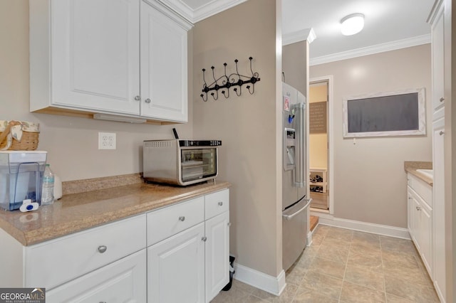494 Thrash Rd, Lagrange, GA 30241 - kitchen with stainless steel fridge with ice dispenser, baseboards, crown molding, and white cabinetry
