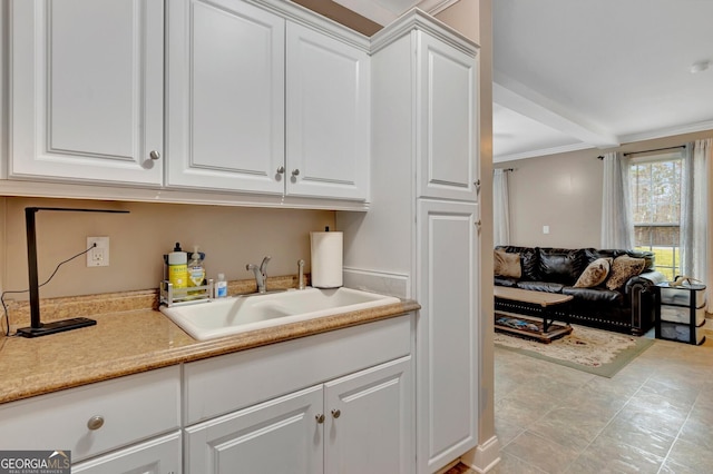 494 Thrash Rd, Lagrange, GA 30241 - kitchen featuring a sink, white cabinetry, light countertops, and open floor plan