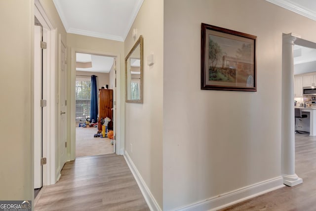 494 Thrash Rd, Lagrange, GA 30241 - hallway featuring crown molding, light wood-type flooring, baseboards, and decorative columns
