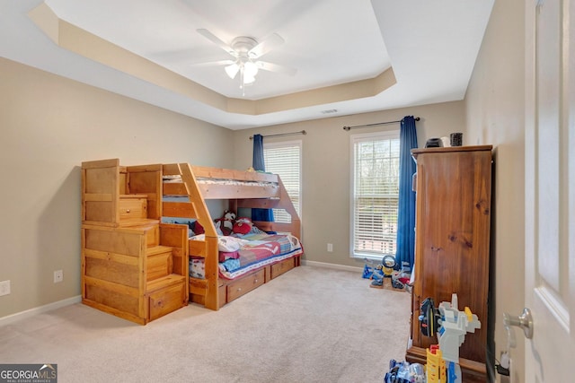 494 Thrash Rd, Lagrange, GA 30241 - carpeted bedroom featuring a raised ceiling, baseboards, and a ceiling fan
