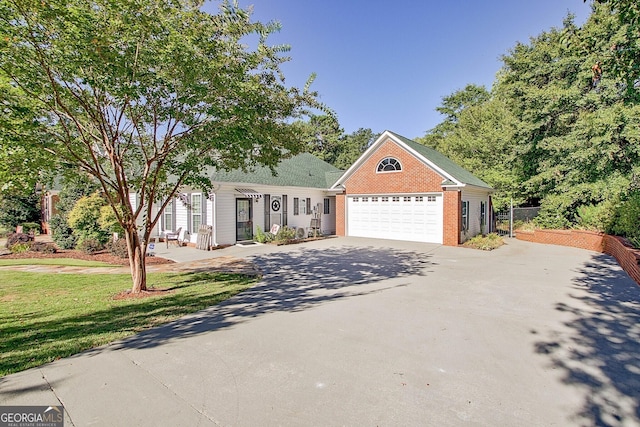 494 Thrash Rd, Lagrange, GA 30241 - view of front of house with concrete driveway, brick siding, a front yard, and an attached garage