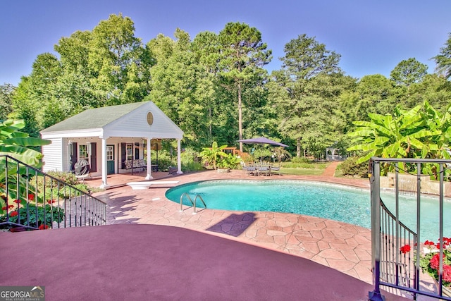 494 Thrash Rd, Lagrange, GA 30241 - swimming pool featuring a patio area, a storage structure, an outbuilding, a diving board, and view of scattered trees