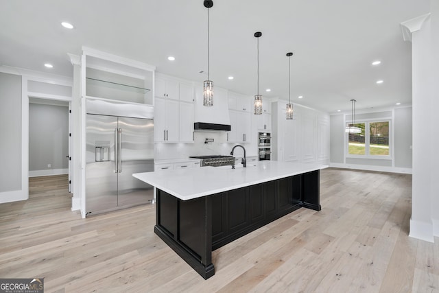 2107 E Maddox Rd, Buford, GA 30519 - kitchen featuring light wood finished floors, built in refrigerator, light countertops, and white cabinetry