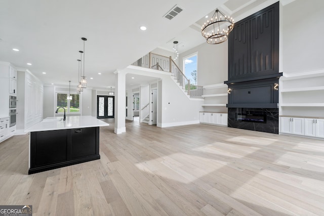 2107 E Maddox Rd, Buford, GA 30519 - kitchen featuring visible vents, a notable chandelier, open floor plan, light countertops, and light wood-style floors