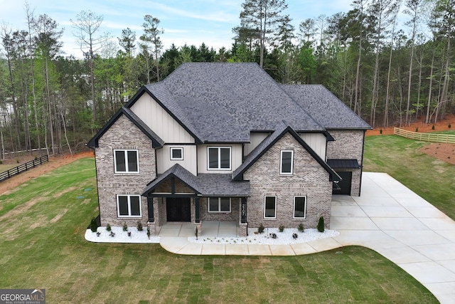 2107 E Maddox Rd, Buford, GA 30519 - view of front facade with board and batten siding, concrete driveway, a front yard, and fence