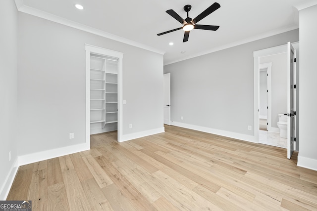2107 E Maddox Rd, Buford, GA 30519 - unfurnished bedroom featuring ornamental molding, recessed lighting, a walk in closet, light wood-type flooring, and a closet