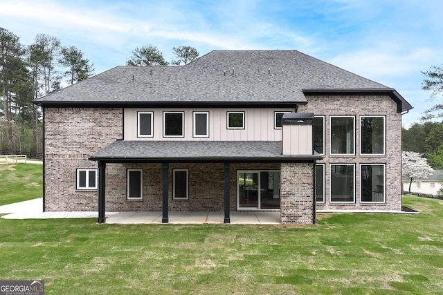 2107 E Maddox Rd, Buford, GA 30519 - rear view of property featuring brick siding, a yard, a patio area, and roof with shingles