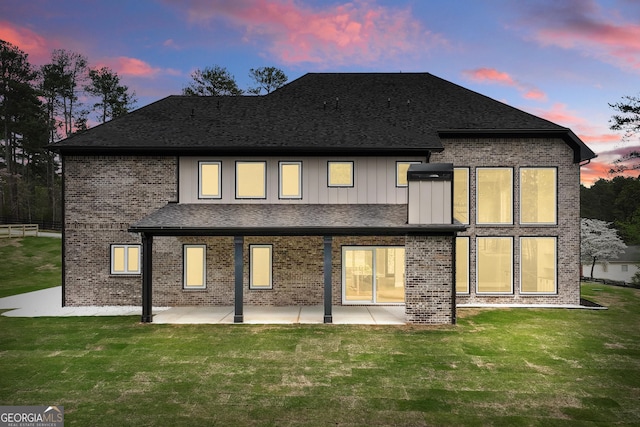 2107 E Maddox Rd, Buford, GA 30519 - back of house with a patio area, a lawn, and brick siding