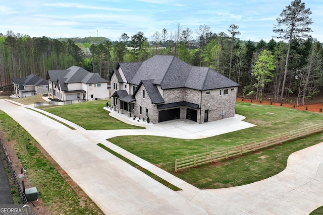2107 E Maddox Rd, Buford, GA 30519 - back of house with stone siding, driveway, an attached garage, a view of trees, and a shingled roof
