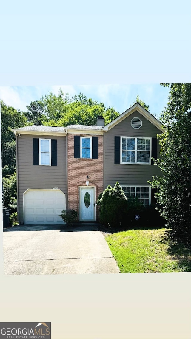 view of front of home featuring brick siding, driveway, and a garage