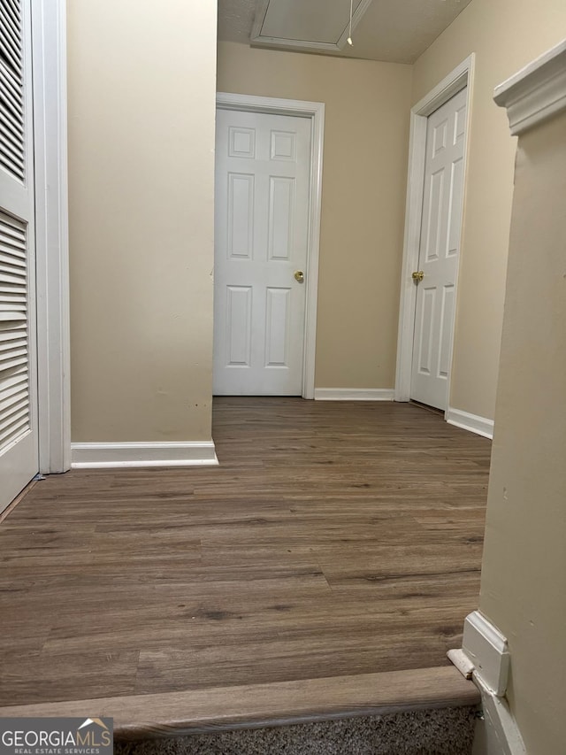 unfurnished bedroom with baseboards and wood finished floors