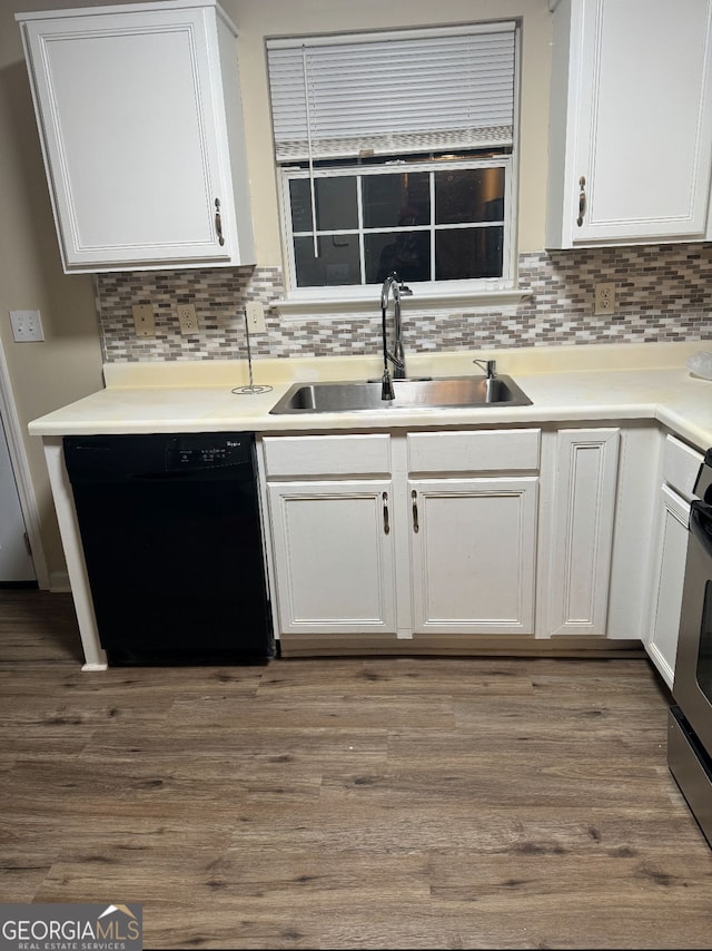 kitchen featuring tasteful backsplash, white cabinets, dishwasher, a sink, and wood finished floors