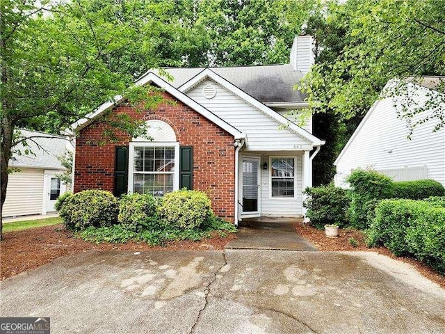 645 Crossbridge Aly, Johns Creek, GA 30022 - view of front of house with a chimney and brick siding