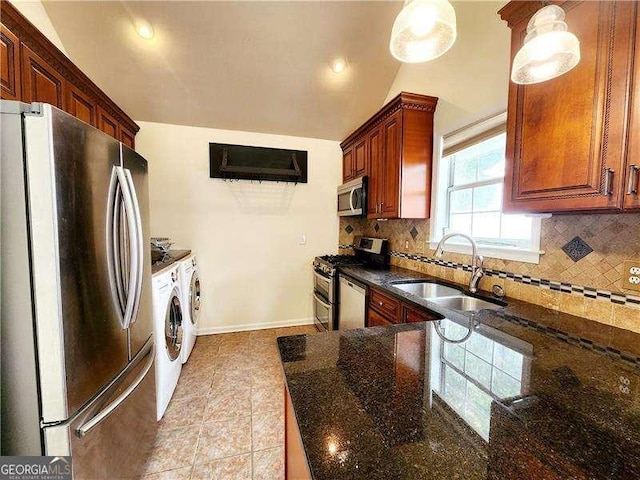 645 Crossbridge Aly, Johns Creek, GA 30022 - kitchen featuring dark stone countertops, a sink, stainless steel appliances, decorative backsplash, and washing machine and dryer