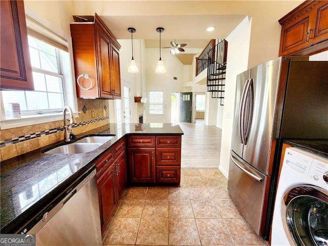 645 Crossbridge Aly, Johns Creek, GA 30022 - kitchen with a sink, a peninsula, backsplash, stainless steel dishwasher, and washer / dryer