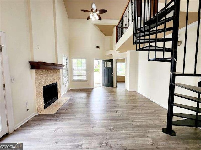 645 Crossbridge Aly, Johns Creek, GA 30022 - unfurnished living room with a fireplace with flush hearth, a ceiling fan, visible vents, wood finished floors, and baseboards