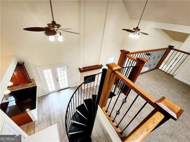 645 Crossbridge Aly, Johns Creek, GA 30022 - staircase with french doors, high vaulted ceiling, a ceiling fan, and wood finished floors