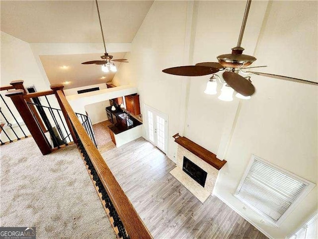 645 Crossbridge Aly, Johns Creek, GA 30022 - unfurnished living room featuring high vaulted ceiling, ceiling fan, a fireplace with flush hearth, visible vents, and french doors