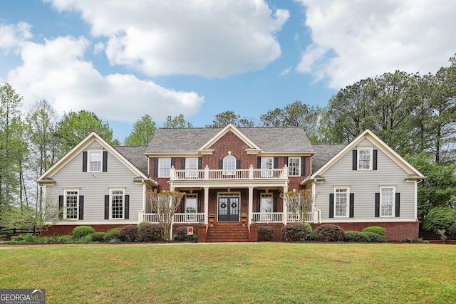 view of front of property with brick siding, a front yard, covered porch, and a balcony